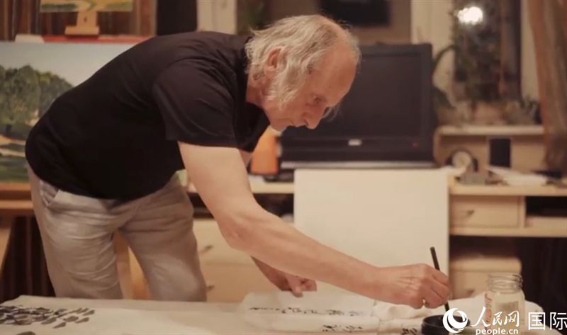 伊戈?duì)枴げ紶枛|諾夫在畫作上題詞。人民網(wǎng)記者 馬天翼攝