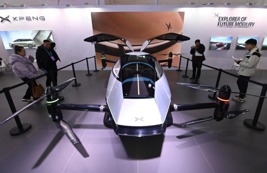 2023年12月1日，在鏈博會智能汽車鏈展區(qū)小鵬汽車展臺，參觀者觀看一臺智能飛行器。新華社記者蔡湘鑫攝