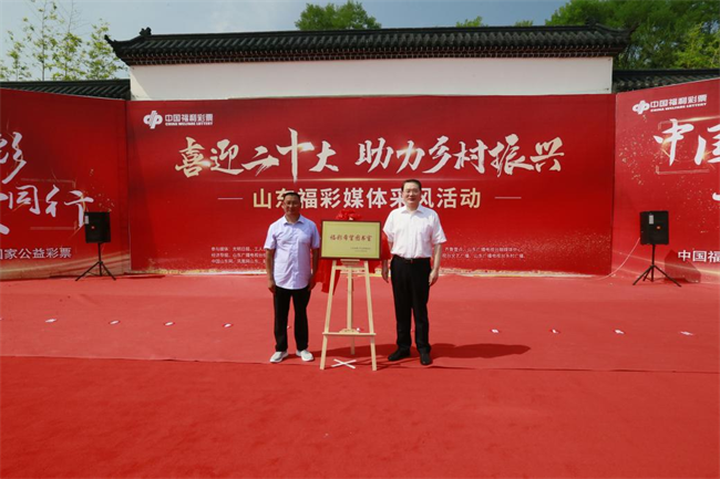 省福彩中心主任王偉與沂源縣徐家莊中心學校校長傅懷佳共同為“福彩希望圖書室”揭牌。 山東省福彩供圖）