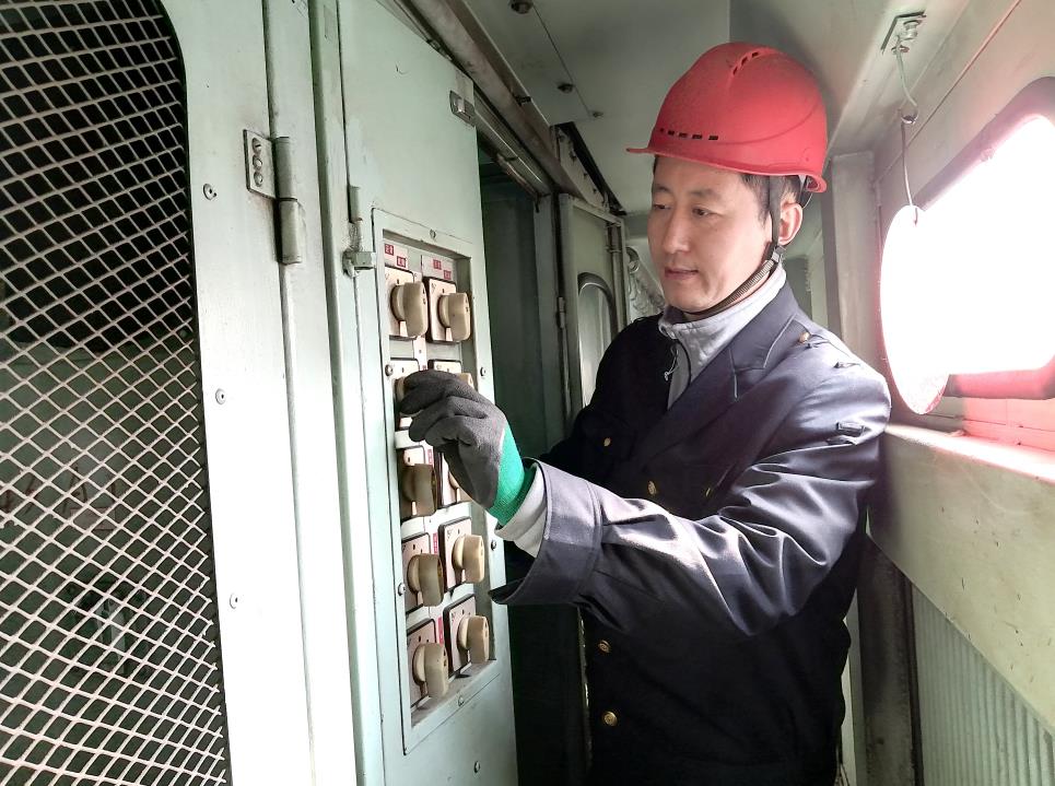 韓文盛認(rèn)真檢查低壓柜。