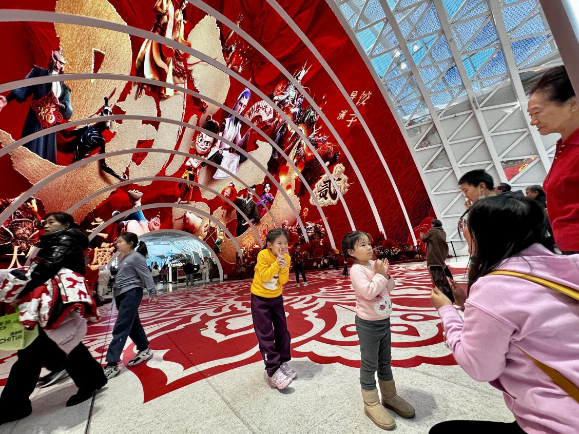 乙巳蛇年春節(jié)期間，影迷在《哪吒之魔童鬧海》巨幅海報(bào)前拍照打卡。