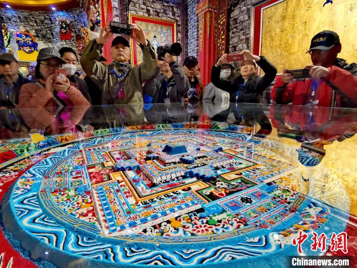 圖為參觀者拍攝壇城?！?zhí)砀?攝